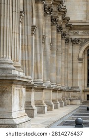 Vertical crop of massive stone columns and base molding with a glimpse of