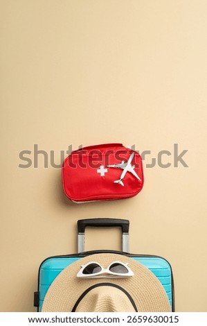 A vertical display of essential items for a safe and enjoyable travel experience, including first aid kit, suitcase, and accessories, arranged creatively on a beige backdrop