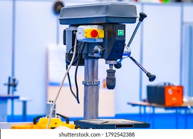 Vertical drilling machine close-up. Drill press with a vise. Equipment for Metalworking. Drilling equipment in the workshop. Machine for drilling holes in metal parts. - Powered by Shutterstock