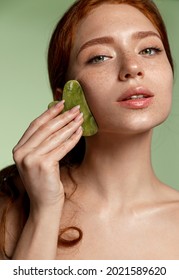 Vertical female, beautiful ginger massage face, lifting facial procedure, skin care concept, using jade scraper, guasha tcm cosmetology to reduce wrinkles, fix blood flow