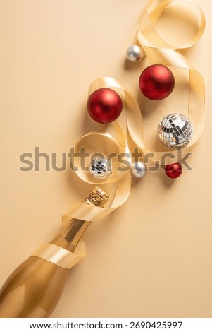 Vertical festive composition featuring champagne bottle, satin ribbon, red and silver baubles, and a disco ball to evoke holiday warmth and celebration for Christmas and New Year greetings