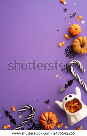 A vertical festive Halloween background featuring candy, pumpkins, and spooky decorations on a purple surface