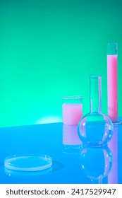 Vertical frame with laboratory concept for advertising product. Boiling flask, test tube, beaker and petri dish filled with pink liquid decorated on green gradient background