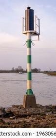 Vertical Frame Of Weather Forecast Air Pressure Wind Data Collection Mast Station On The Edge Of River IJssel Against A Blue Sky With Clouds At Sunset