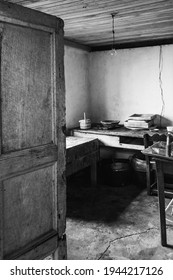 A Vertical Grayscale Shot Inside Of An Old Colombian House