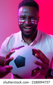 Vertical Image Of African American Male Soccer Fan With Flag Of England In Neon Pink Lighting. Sport, Fans, Cheering And Emotions Concept.