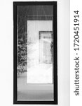 Vertical image of black window frames with glass transparent Windows arranged in perspective and rhythm according to the composition