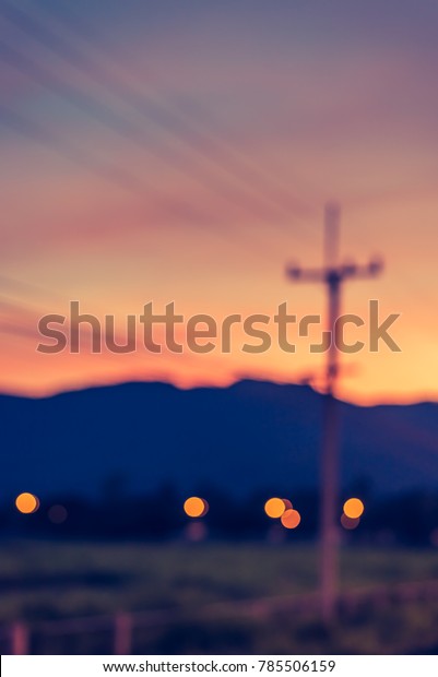 vertical image of blur car on road on\
evening time for background usage. (vintage\
tone)