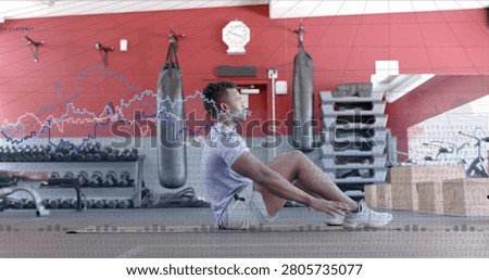 Vertical image: Man tensing core and doing sit-ups on gym mat, waveform tracking reps for fitness. Abdominals, training, workout, facility, weights, bench, sideview