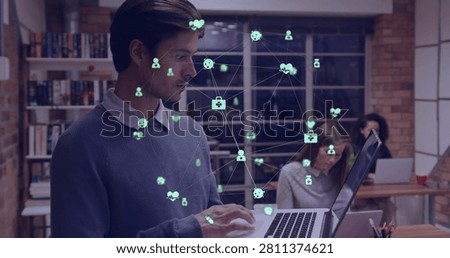 Vertical image: Man typing laptop at office creating green network icons and lines showcasing tech. Coworking, collaboration, presentation, devices, openplan, bookshelves, window