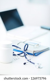 Vertical Image Of Medical Stuff Being Arranged On Desk