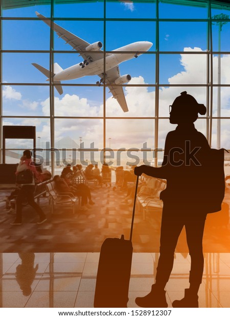 Vertical image of Silhouettes passenger airport. Airline travel concept.