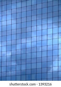 Vertical image of sky reflection on glass wall building