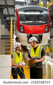 Vertical image of technician worker or engineer man try to explain the data on paper that he carry to his co-worker woman and stay in front of factory workplace or maintenance center.