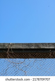 Vertical image of top of wood and chicken wire cage or enclosure