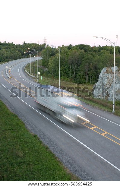 Vertical Image of Tractor Trailler in Motion on\
Major Highway