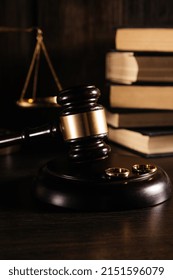 Vertical Image Of Wedding Rings On Wooden Mallet At Table In Courtroom