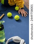 Vertical image. Woman sitting on yoga mat after warmup before strenght training