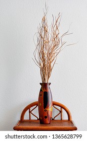 Vertical Image Wooden Painted Ornament Vase And Dry Flower Arrangement Twigs Ikebana On Nightstand Table Over White Wall, Room Decoration Pretty Brown Colour Element, No People