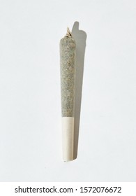 A vertical isolated shot of a marijuana blunt on white background
