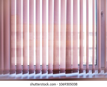 vertical jalousie blinds on the window on a sunny day, sunshine through window