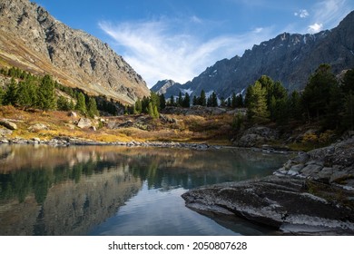 vertical landscape of alpine lake with a mountain peak in the background