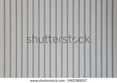 vertical lined texture. surface of the wall with a decorative. textured concrete wall with vertical lines and stripes as a texture.