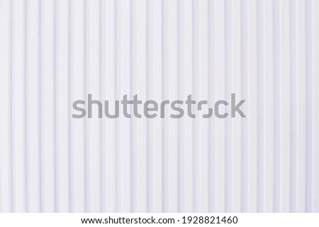 Vertical lines in a repeating pattern; background texture or design of striped lines