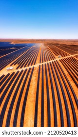 Vertical Lines Of Solar Panel Elements At Broken Hill Solar Plant On Red Soil In Australian Outback - Aerial View.