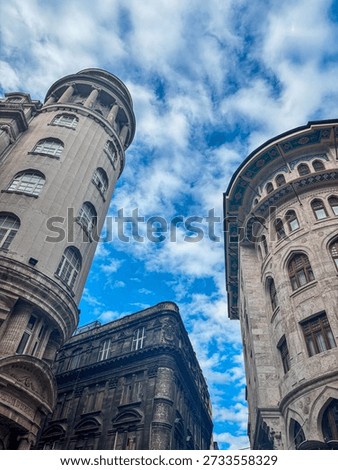 Vertical low angle shot of historical Bankalar Caddesi buildings against blue sky and clouds
