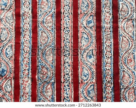 Vertical multi block-printed border on rich rust cotton, unfolding in layered motifs and earthy artisan tones.