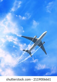 Vertical nature background with aircraft and Jet trailing smoke in the sky. Airplane and condensation trail. Foggy trail jet and plane in blue sky with white clouds. Traveling the world concept - Shutterstock ID 2119006661