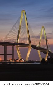 Vertical night image of the illuminated Arthur Ravenel Bridge over the Cooper River in South Carolina, connecting downtown Charleston and Mount Pleasant.