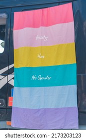 Vertical outdoor shot of a colourful pride month flag. Beauty has no gender. Fighting gender stereotypes. Equality Parade. High quality photo