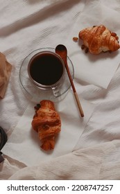 Vertical Overhead Shot Of Freshly Baked Croissants And Black Coffee For A Simple French Breakfast