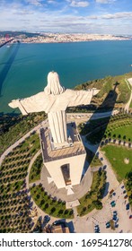 Vertical panoramic view of Cristo Rei statue (The Sanctuary of Christ the King)  overlooking the city of Lisbon situated in Almada, Portugal