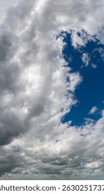 Vertical panoramic view of dramatic cloudy sky with light breaking through