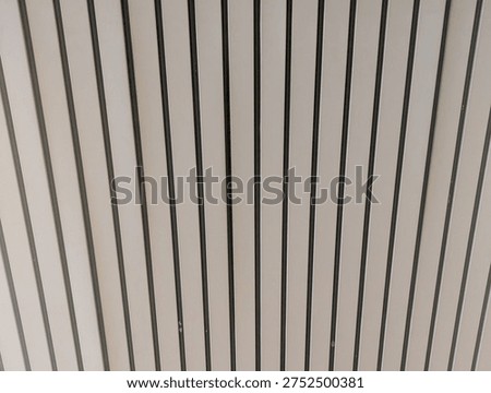 Vertical parallel lines pattern on a modern architectural wall surface.
