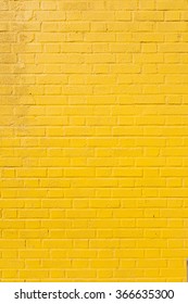 vertical part of bright yellow painted brick block wall