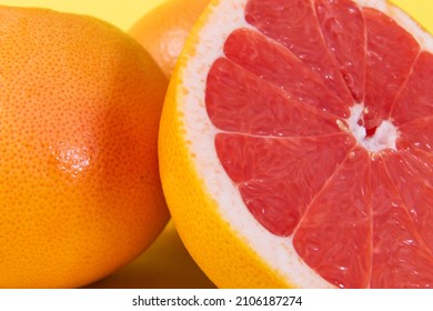 vertical photo of cut red grapefruit in close-up