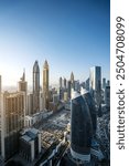 Vertical photo of Dubai International Financial District. Mega skyscrapers. Mix of office and residential tall buildings. Beautiful skyline. Golden hour. 