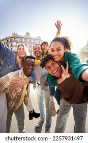 Vertical photo of a group of cheerful students college friends having fun together as they travel European city Happy community of diverse people. Selective focus on the smily couple taking the selfie - Shutterstock ID 2257931497