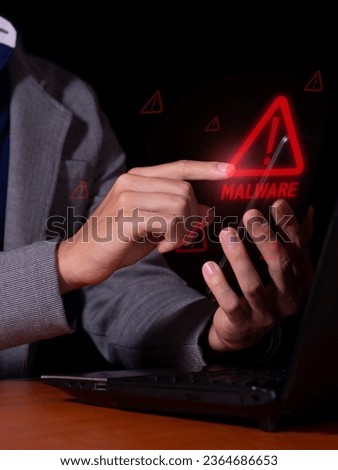 Vertical photo of a man receives malware notifications for digital intrusions and cybercrime on his smartphone and laptop.