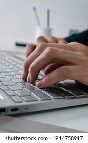 Vertical Photo Of A Man Typing On His Laptop, Wearing A Suit And A Titanium Watch, Labor Day.