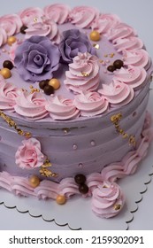 A vertical photo of pink buttercream cake with buttercream frosting