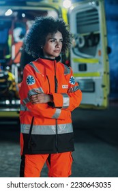 Vertical Photo: Portrait of Beautiful, Multiethnic, Female Paramedic Specialist on Late Night Shift. Heroic Empowering Woman Seriously Looking Away and posing for Camera, Reporting for Duty