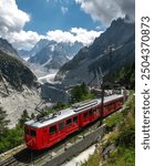 Vertical photo of the red mountain train from Chamonix to Mont-Blanc, Mer de Glace glacier in Valle Blanche. Travel destination in France, Auvergne, Rhône-Alpes.