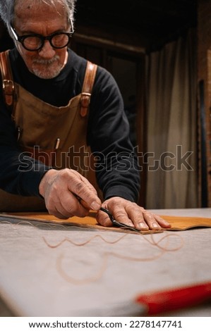 Similar – Alte Hände eines Töpfers, der eine Tonfigur formt.