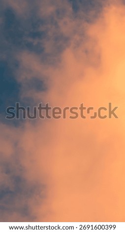 A vertical photograph captures a dramatic sky scene, likely at sunrise or sunset.