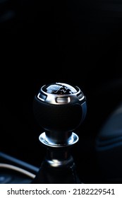 Vertical Photograph Of The Manual Gearshift Lever Of A Luxury Car With Dark Interior